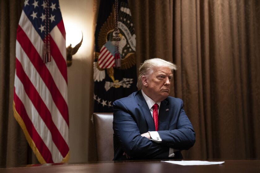 President Donald Trump listens during a meeting with Hispanic leaders in the Cabinet Room of the White House, Thursday, July 9, 2020, in Washington. (AP Photo/Evan Vucci)