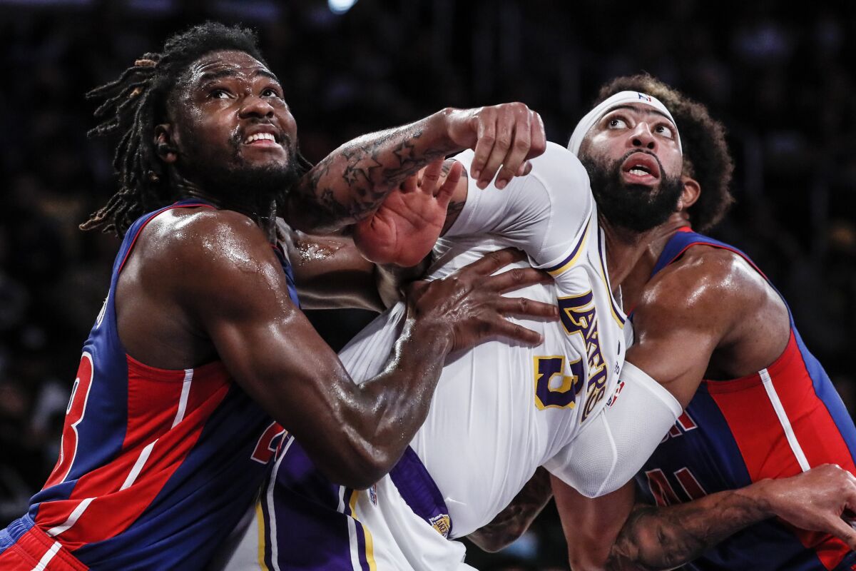 Lakers forward Anthony Davis, right, fights for rebounding position with Pistons center Isaiah Stewart.