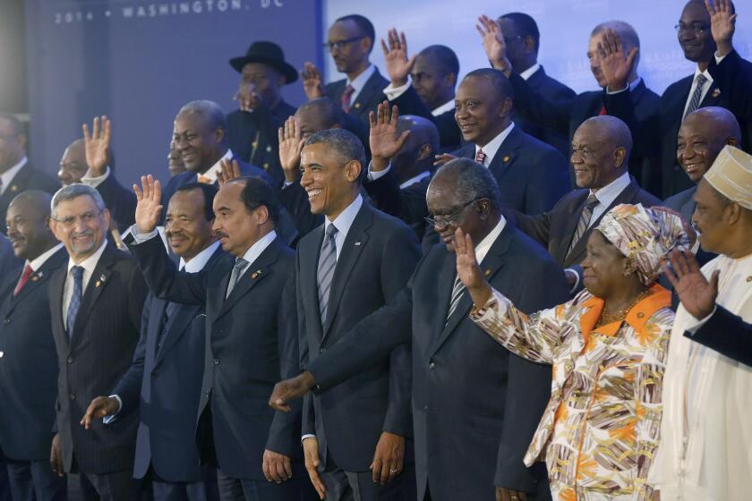 President Barack Obama is surrounded by US Africa Leaders Summit participants in Washington, Wednesday, Aug. 6, 2014, during a family photo. Obama and dozens of African leaders opened talks on two key issues that threaten to disrupt economic progress on the continent: security and government corruption. (AP Photo/Charles Dharapak)