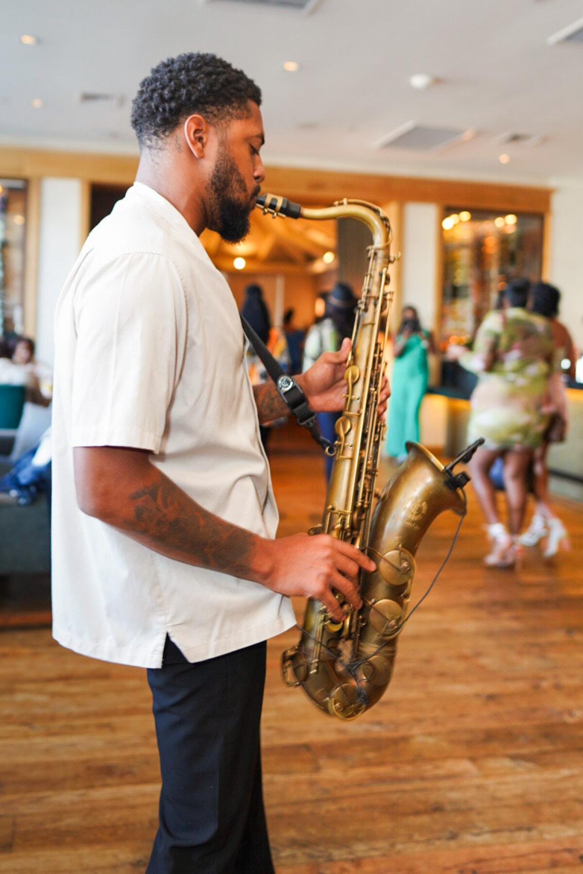 A man plays saxophone.