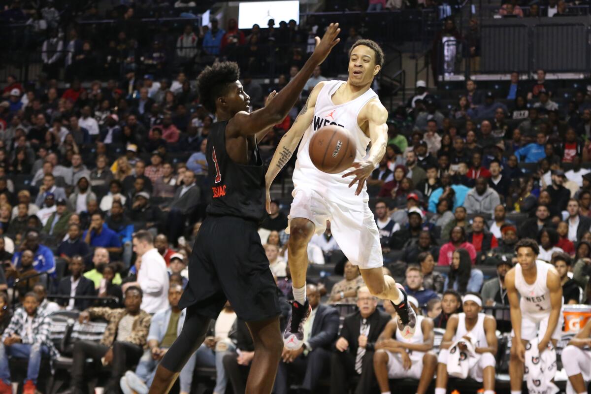 Amir Coffey, right, plays in the Jordan Brand Classic in April 2016.