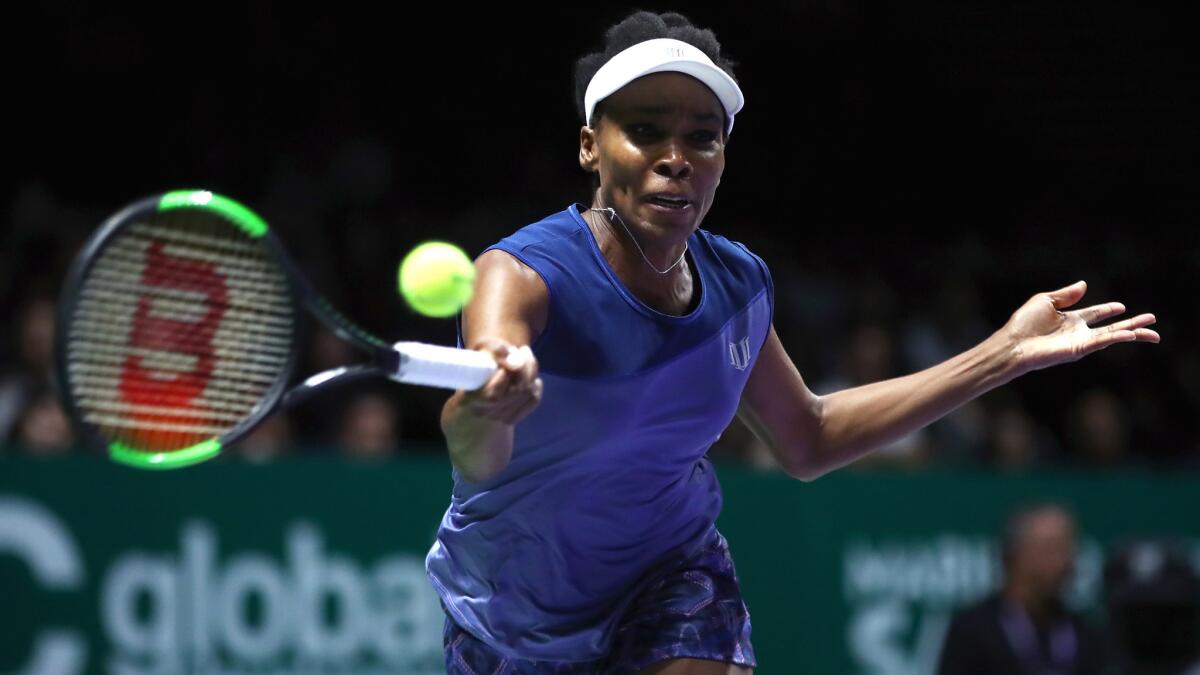 Venus Williams plays a forehand against Caroline Garcia during their match Saturday at the WTA Finals.