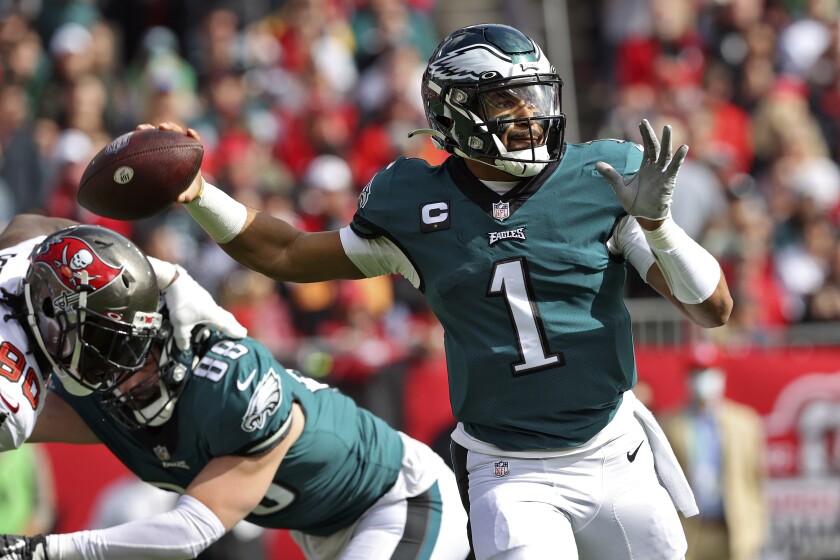 Philadelphia Eagles quarterback Jalen Hurts (1) throws a pass against the Tampa Bay Buccaneers during the first half of an NFL wild-card football game Sunday, Jan. 16, 2022, in Tampa, Fla. (AP Photo/Mark LoMoglio)