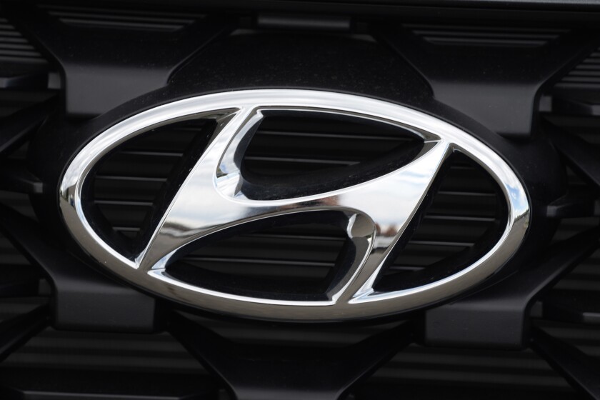 FILE - The Hyundai logo shines off the grille of an unsold vehicle at a Hyundai dealership Sunday, Sept. 12, 2021, in Littleton, Colo. Hyundai is recalling more than 215,000 midsize cars in the U.S., Wednesday, May 11, 2022, most for a second time _ because fuel hoses can leak in the engine compartment and cause fires. The recall covers certain 2013 and 2014 Sonata sedans, many of which were recalled for the same problem in 2020. AP Photo/David Zalubowski, File)