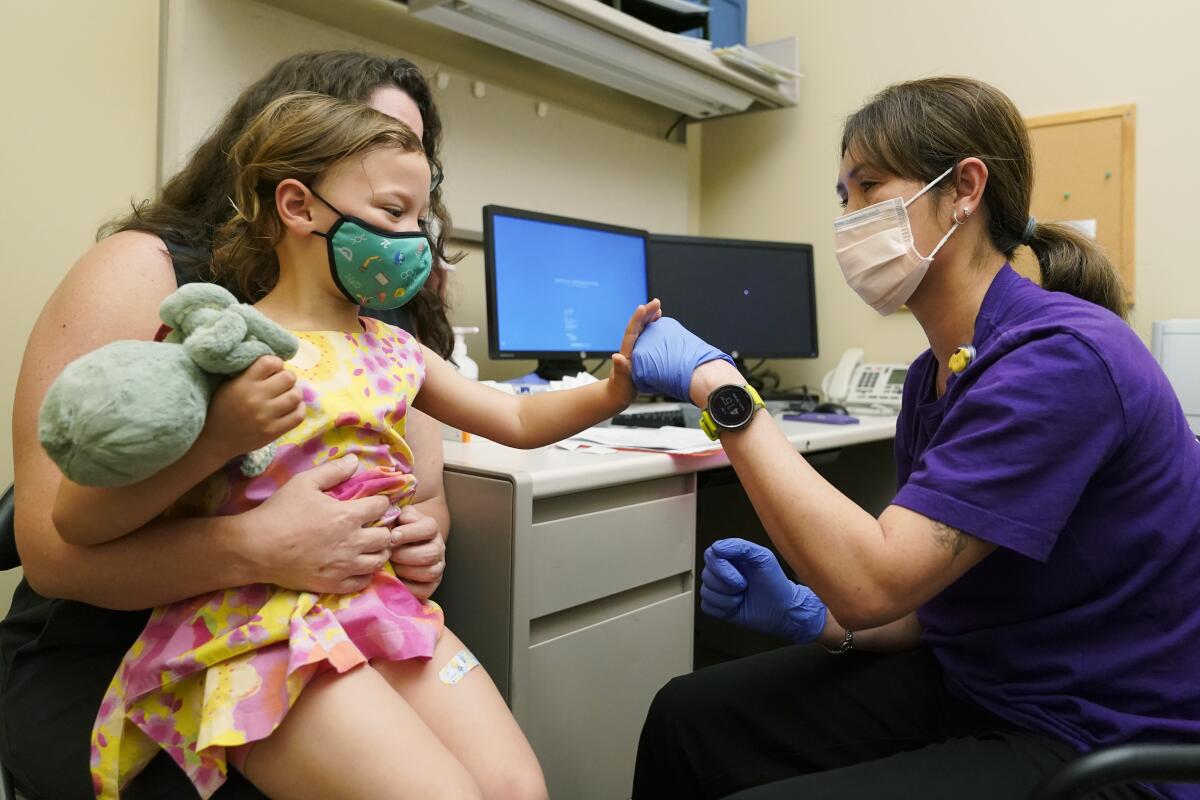 Nora Burlingame, 3, celebrates with nurse Luann Majeed after getting a dose of COVID-19 vaccine in June.