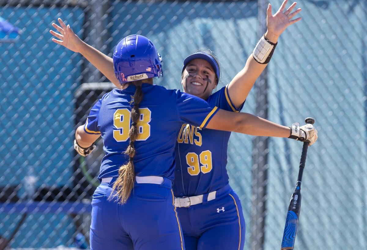 Fountain Valley's Makenzie Butt gets a celebratory hug from Veronica Moore after hitting a solo home run.
