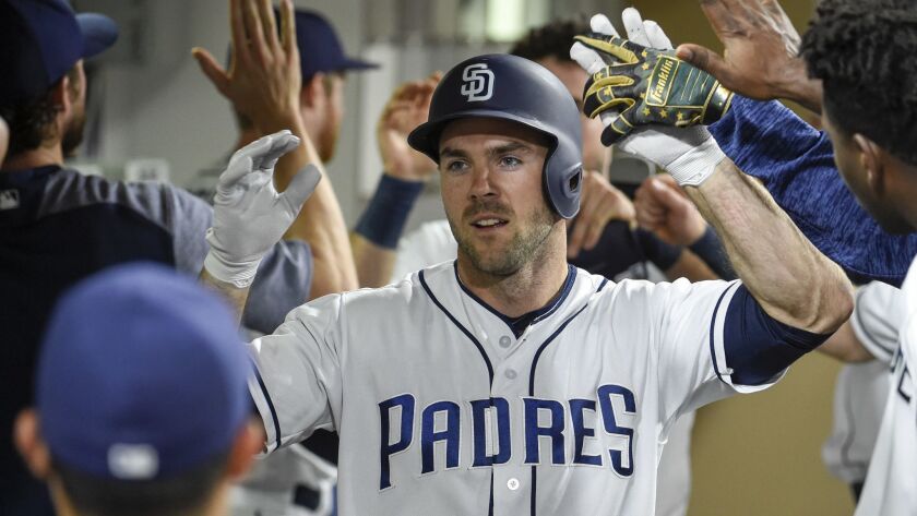 The Padres' Matt Szczur is congratulated after scoring during the fifth inning of a baseball game against the Pittsburgh Pirates at Petco Park on June 30, 2018 in San Diego, California.