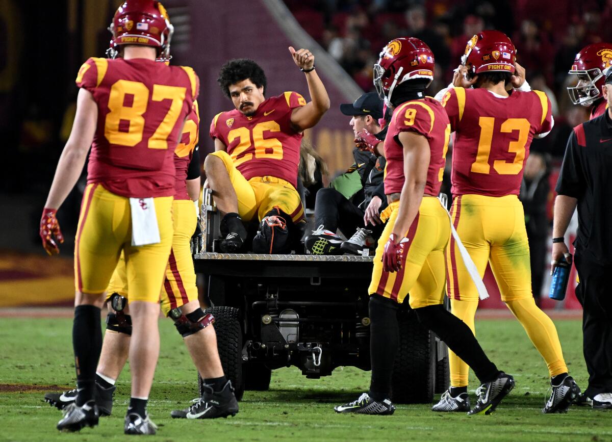 USC running back Travis Dye is carted off the field after a second-quarter leg injury against Colorado on Nov. 11, 2022.