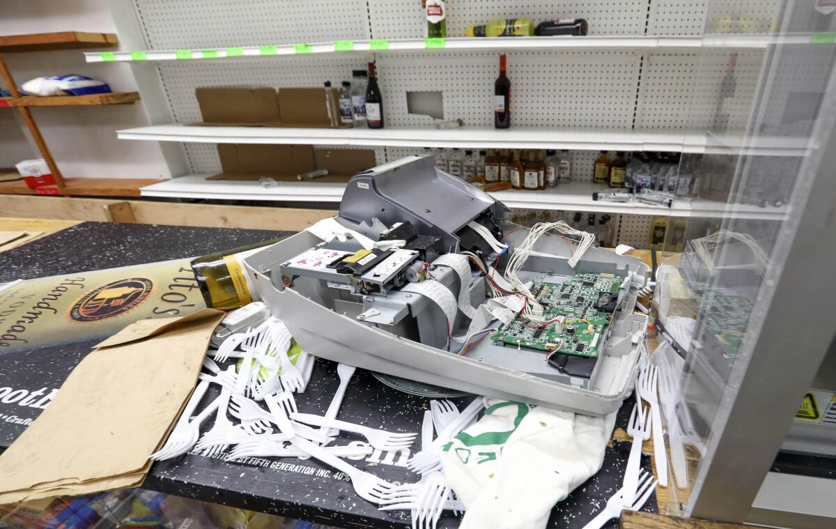 A broken cash register sits on the counter of African Food & Liquor in Chicago, Thursday, Aug. 13, 2020. The West Side convenience store was ransacked Monday just hours after Chicago Mayor Lori Lightfoot warned vandals that the city will hold them accountable for ransacking downtown retailers earlier that day. It was the second time since May that the neighborhood store was vandalized. (AP Photo/Teresa Crawford)