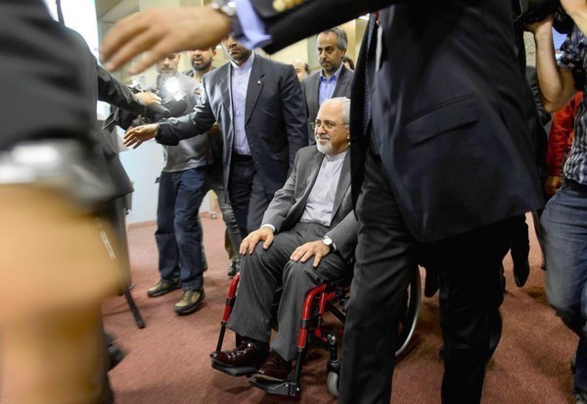 Iranian Foreign Minister Mohammad Javad Zarif leaves a news conference after two days of talks in Geneva. The Iranian blames pressure from hard-liners in his country for his intense back pain that has left him nearly immobilized.