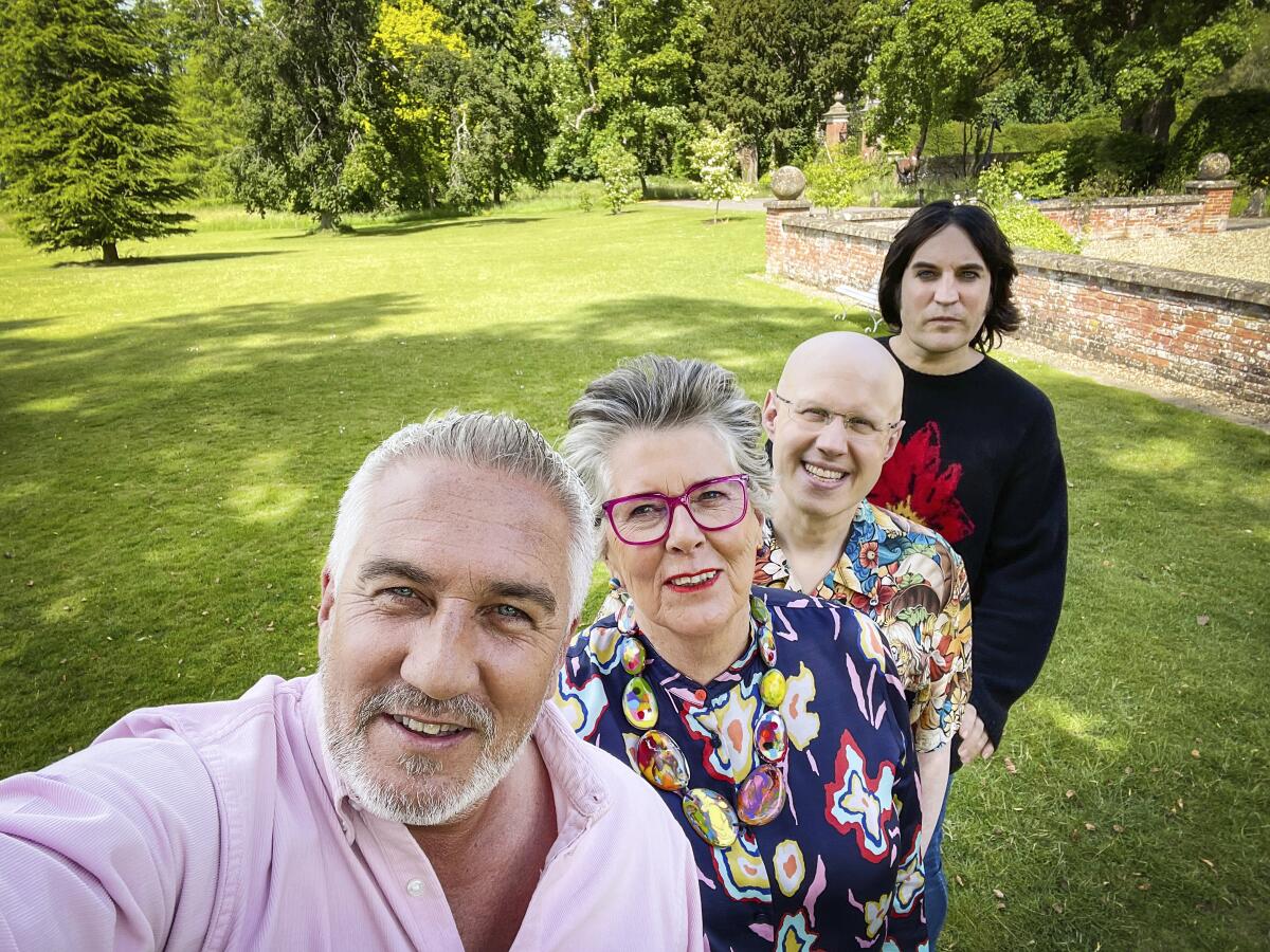 Four people pose for a selfie on the grounds of a British estate