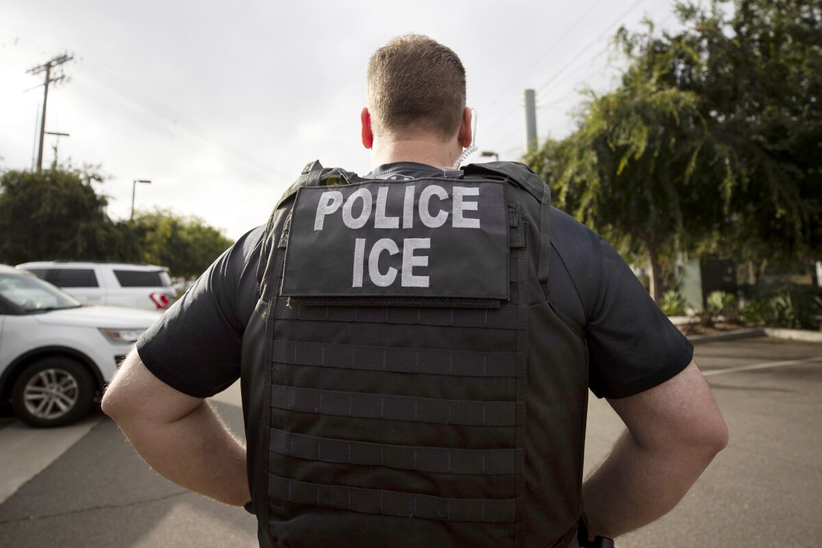FILE - A U.S. Immigration and Customs Enforcement (ICE) officer looks on during an operation in Escondido, Calif., July 8, 2019. Immigration enforcement arrests in the interior of the U.S. fell over the past year as the Biden administration shifted its enforcement focus to people in the country without legal status who have committed serious crimes. (AP Photo/Gregory Bull, File)