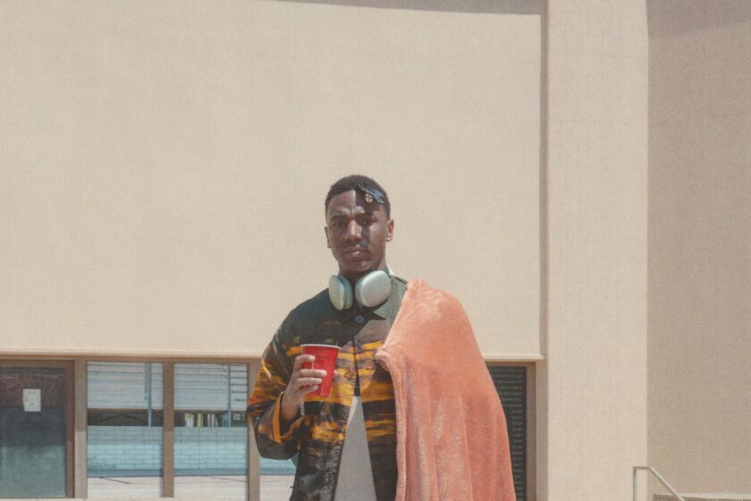  Jerrod Carmichael is photographed imitating a statue that once stood in this exact spot in Santa Monica as Carmichael wanted