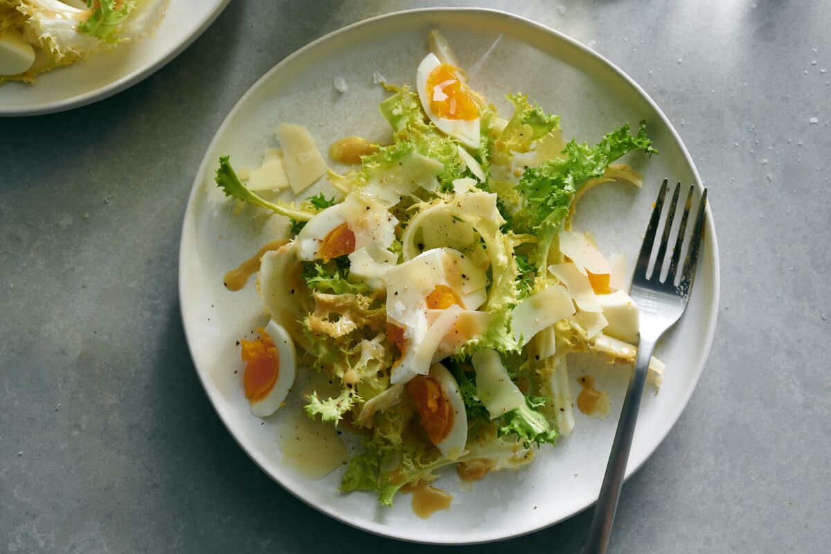 Curly endive salad with mustard dressing, egg and Gruyère.