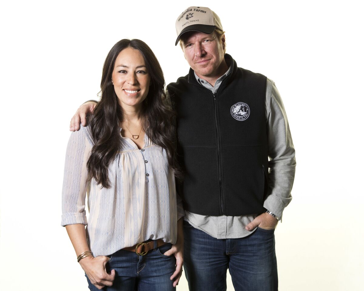 FILE - In this March 29, 2016, file photo, Joanna Gaines, left, and Chip Gaines pose for a portrait in New York to promote their home improvement show, "Fixer Upper," on HGTV. The “Fixer Upper” series, which ran for five seasons before airing its final episode in April 2018, is coming back and will air exclusively on Magnolia Network when it launches in 2021. (Photo by Brian Ach/Invision/AP, File)