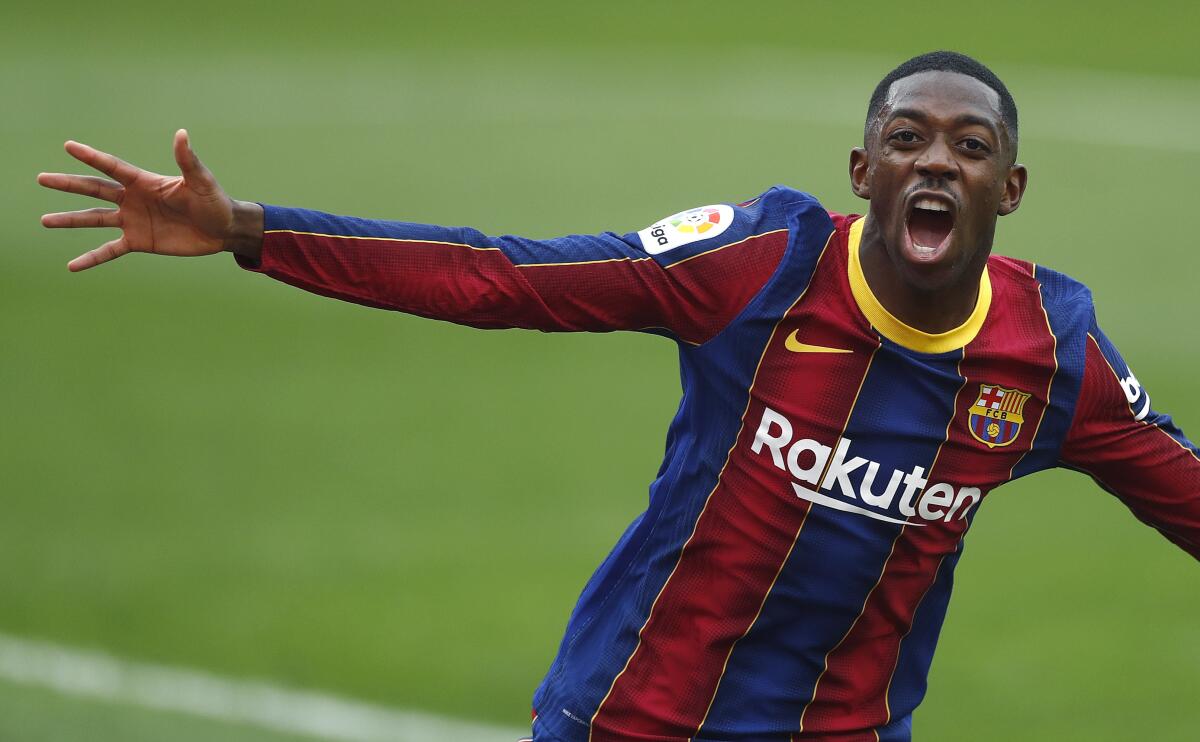 FILE - Barcelona's Ousmane Dembele celebrates after scoring during a Spanish La Liga soccer match between Sevilla and Barcelona at the Ramon Sanchez-Pizjuan stadium in Seville, Spain, Saturday Feb. 27, 2021. Barcelona wants to sell France winger Ousmane Dembele before the close of the winter transfer window, a top club official said Thursday, Jan. 20, 2022. Barcelona soccer director, Mateu Alemany, said that the club has told Dembele that he needs to find a new club after having refused to sign a new deal with Barcelona with his current contract expiring in June. (AP Photo/Angel Fernandez, File)