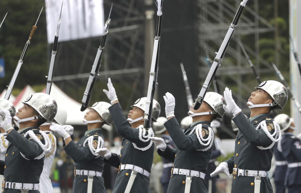 The military honor guard perform during the National Day celebrations in front of the Presidential Building in Taipei, Taiwan, Monday, Oct. 10, 2022. (AP Photo/Chiang Ying-ying)