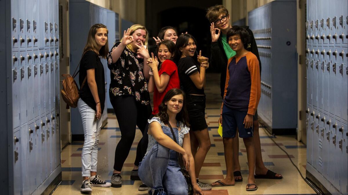 Kaylee Leffler, left, Elizabeth Heuer, Gisele Ortiz, Leila Curran, Emily Cliborn, Heather Morales, Jake Eaton and Asher Burstin pose for a portrait after discussing Bo Burnham's "Eighth Grade."