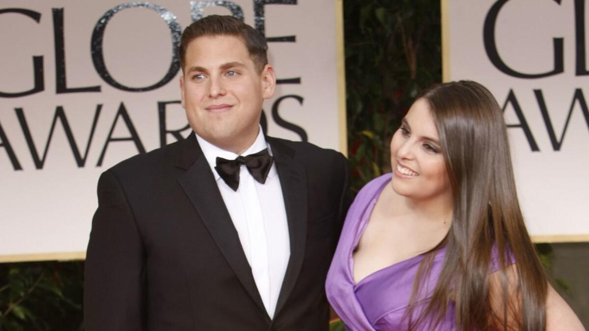 Hill attends the Golden Globe Awards with his sister, Beanie Feldstein, in 2012.