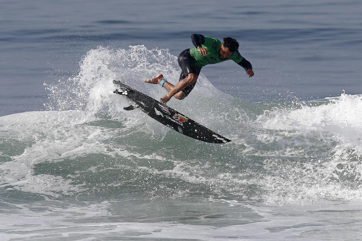 Brazil's Italo Ferreira pulls a kick flip as he competes against Kanoa Igarashi during the World Surf League finals Thursday.