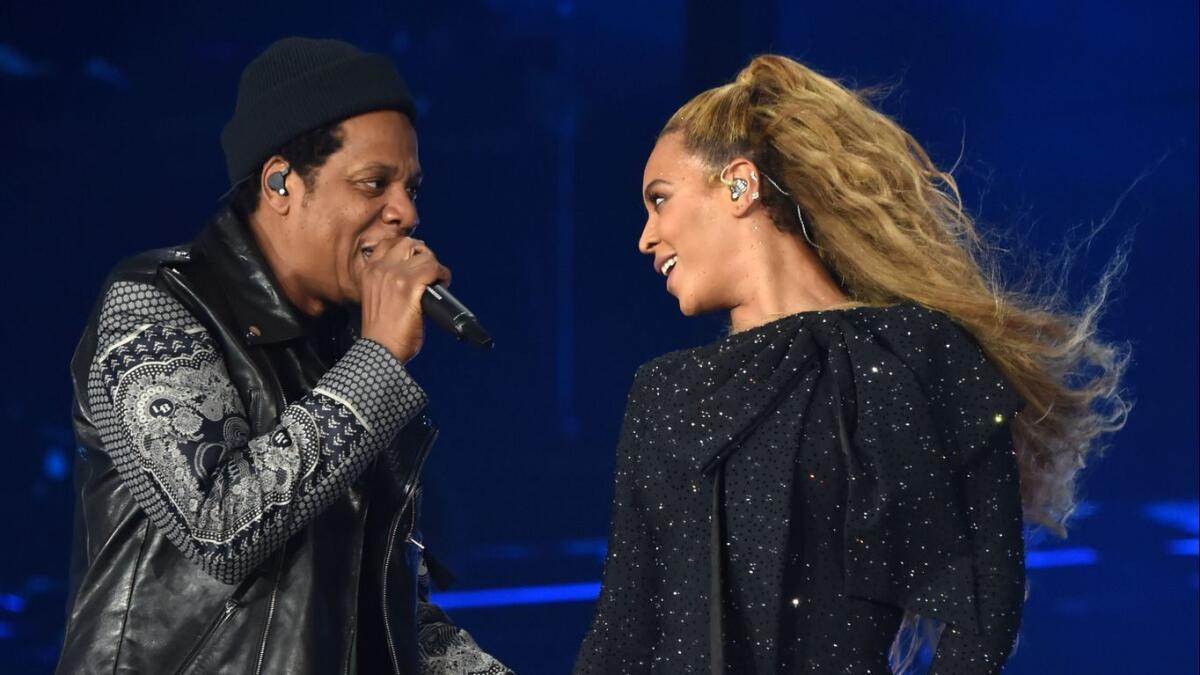 Beyonce and Jay-Z perform together on stage during the "On the Run II" Tour.