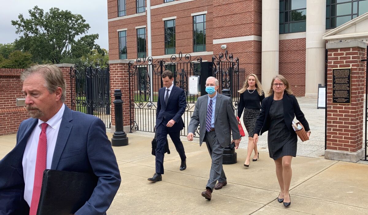 Former SCANA CEO Kevin Marsh, center, walks out of a courtroom with his lawyers after being sentenced to two years in prison for lying and deceiving the public about the progress of a pair of nuclear reactors in South Carolina that were never finished and wasted billions of dollars on Thursday, Oct. 7, in Columbia, S.C. Marsh also has pleaded guilty in state charges in the case. (AP Photo/Jeffrey Collins)