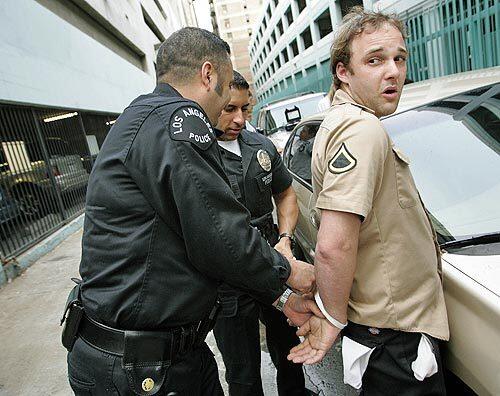 Actor Brad Renfro is handcuffed by LAPD officers after being arrested for allegedly buying what he thought was heroin from undercover police posing as drug dealers on Spring St. near 6th st. in Downtown Los Angeles on Thursday afternoon.