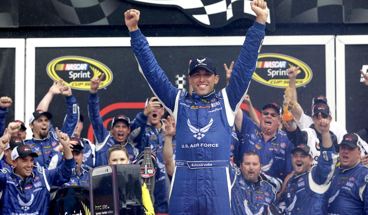 Aric Almirola celebrates in Victory Lane after winning the NASCAR Sprint Cup Series Coke Zero 400 on Sunday at Daytona International Speedway.