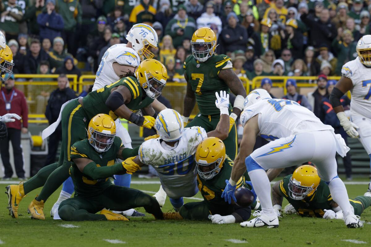 Players scramble for a fumble by the Chargers' Austin Ekeler (30), recovered by the Green Bay Packers.