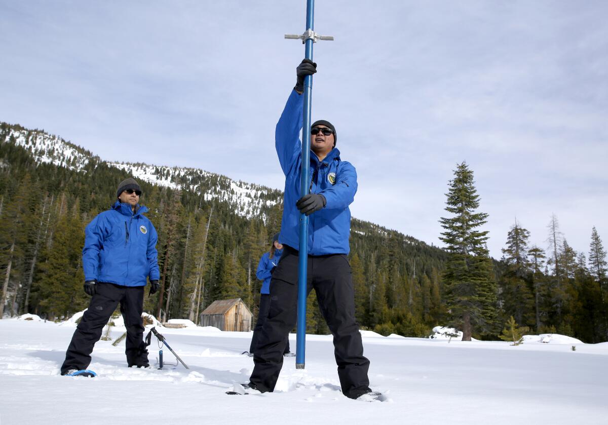 Sean de Guzman, chief of snow surveys for the California Department of Water Resources, measures the snowpack during the first survey of the season at Phillips Station near Echo Summit, west of Lake Tahoe.