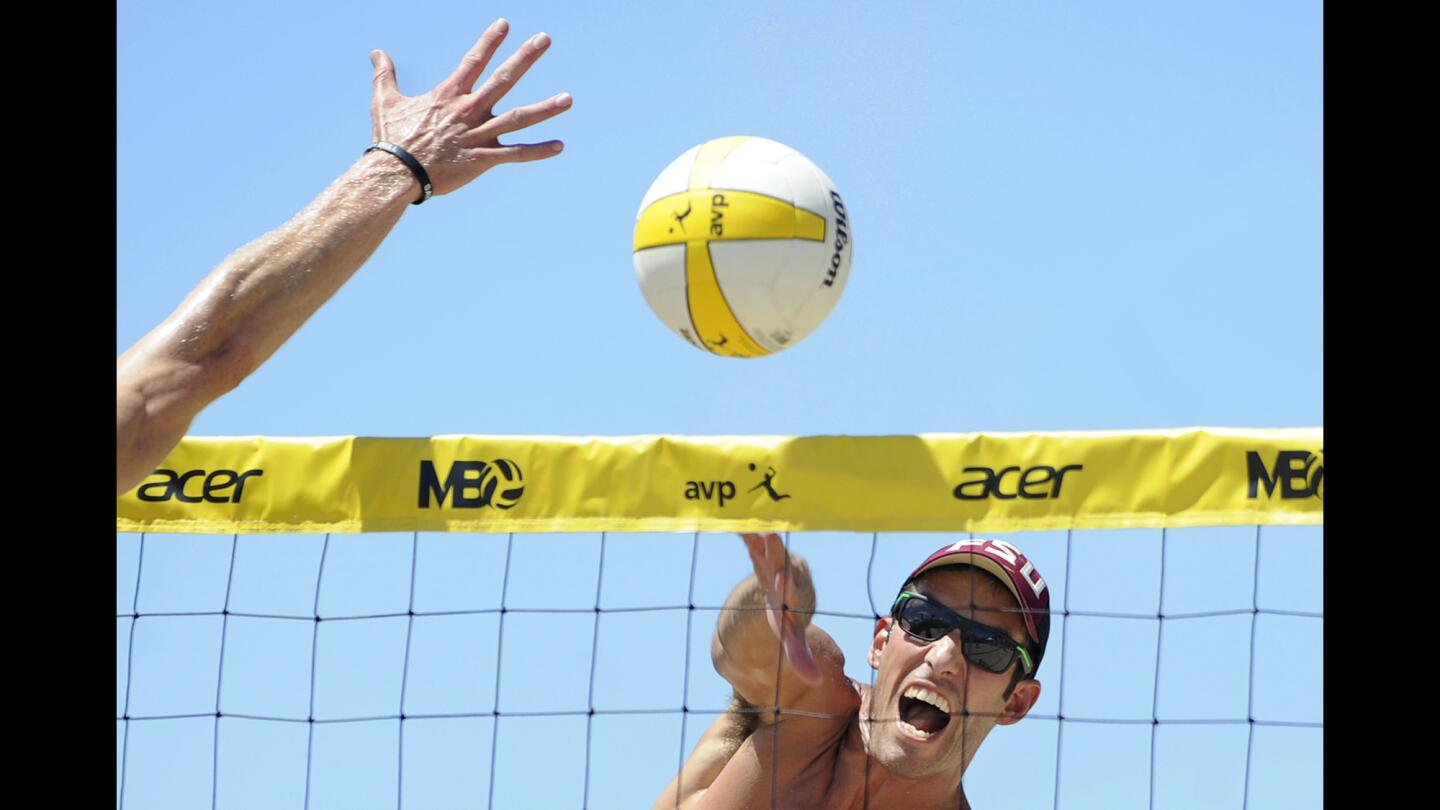 Nick Lucena spikes the ball during the AVP Manhattan Beach Open men's championship match on Sunday.