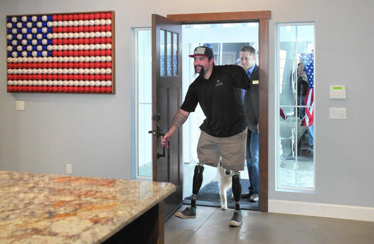 Marine Sgt. Nick Kimmel, whose legs and arm were amputated after he was wounded in Afghanistan, enters his new home in Fallbrook. The custom smart home has wide hallways, lowered countertops and window blinds controlled via iPad.