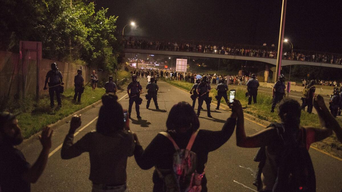 Demonstrators link hands on Interstate 94 on July 9, 2016, in St. Paul, Minn., to protest the police killing of Philando Castile.