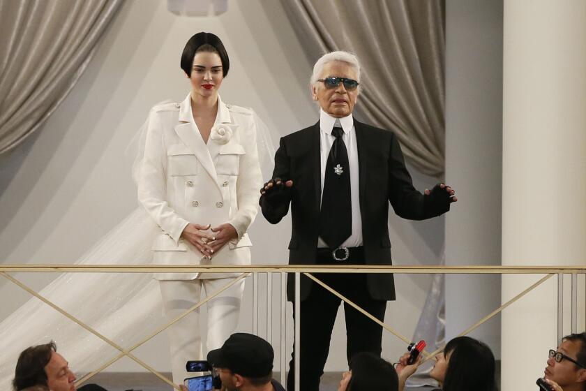 Model Kendall Jenner joins Chanel designer Karl Lagerfeld during the Chanel 2015-2016 fall/winter Haute Couture collection fashion show on July 7, 2015 at the Grand Palais in Paris.
