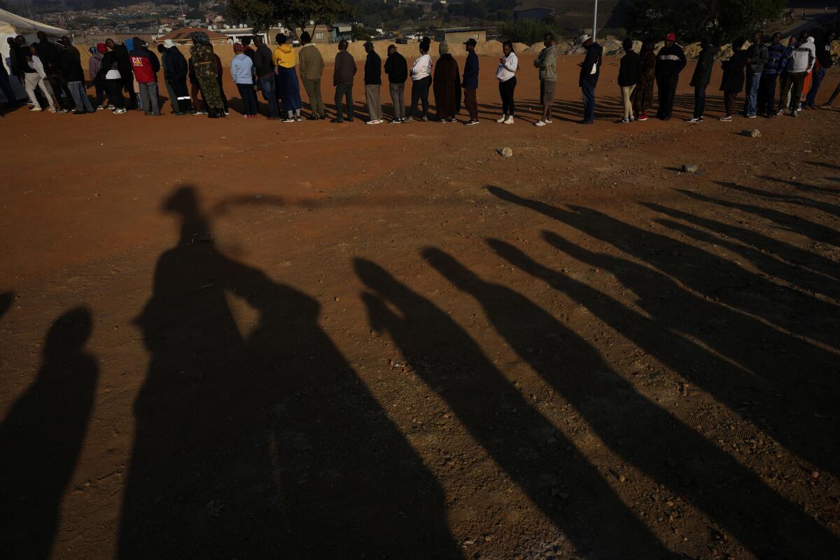 Voters line up to cast their ballot for general election in Alexandra, South Africa.