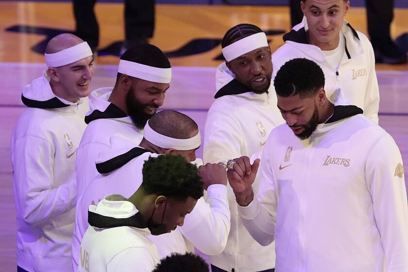 Los Angeles, CA, Tuesday, December 22, 2020 - Los Angeles Lakers forward Anthony Davis (3) taps rings with teammate Jared Dudley during a ring ceremony at Staples Center. (Robert Gauthier/ Los Angeles Times)