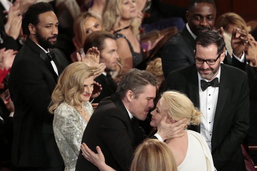 Ethan Hawks congratulates Patricia Arquette, who won supporting actress for "Boyhood."