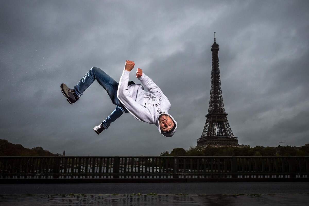 Sofiane, or B-boy Soso, from Melting Force dance crew poses in front of the Eiffel Tower on Bir-Hakeim bridge in Paris. - Breakdancing, surfing, climbing and skateboarding : the Olympic Games Organizing Committee (COJO) for Paris-2024 will unveil on February 21, 2019 a list of "guest sports" for the Paris-2024, which still needs to be validated by the International Olympic Committee (CIO), it was announced on February 20.