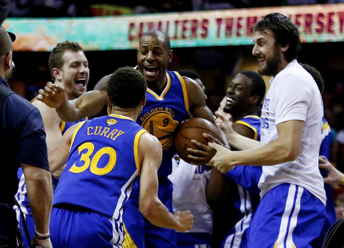Golden State Warriors point guard Stephen Curry joins teammates to celebrate after defeating the Cleveland Cavaliers, 105-97, in Game 6 of the NBA Finals on Tuesday in Cleveland.