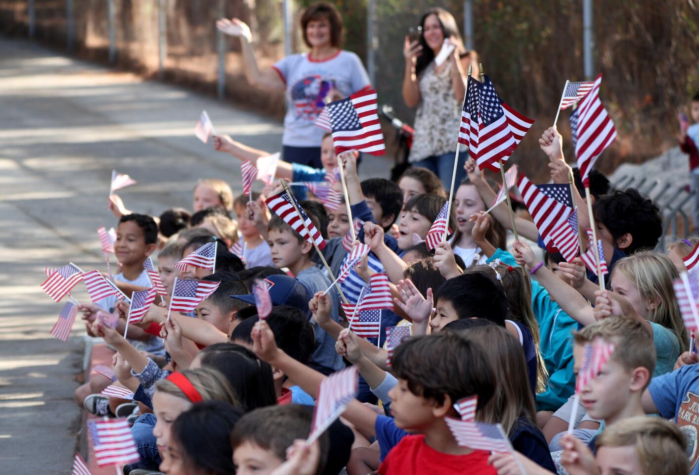Mountain Elementary School students cheer during the annual Crescenta Valley Remembrance Motorcade, organized by members of the Crescenta Valley Chamber of Commerce, in La Crescenta on Wednesday, Sept. 11, 2019.