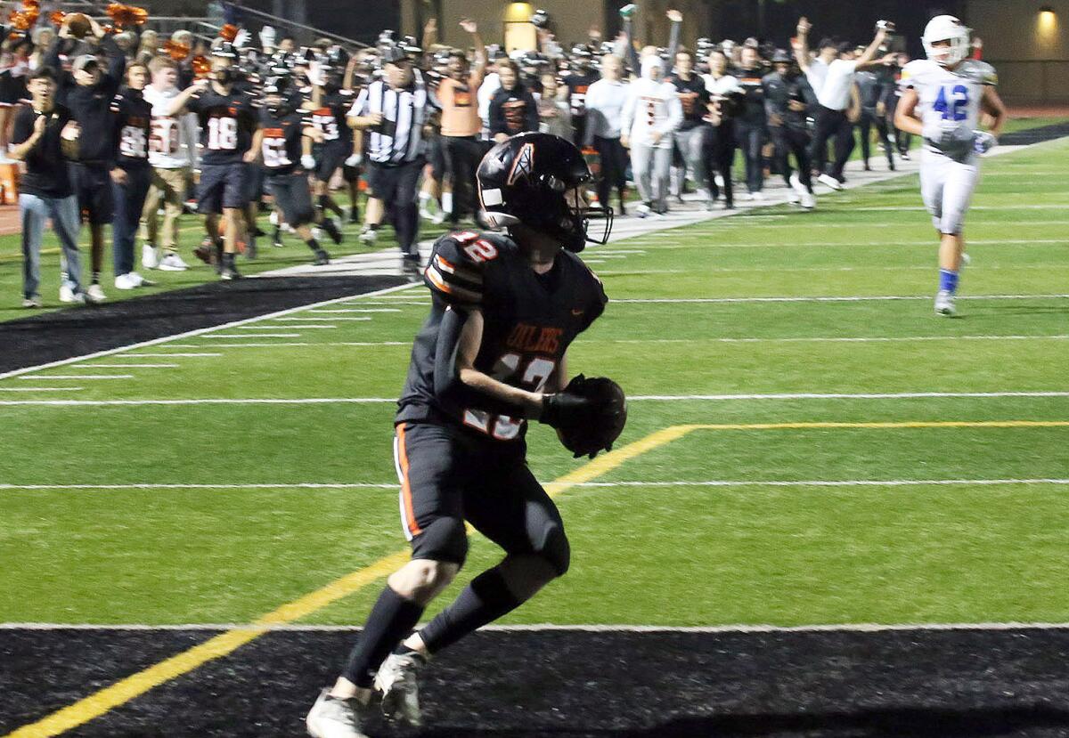 Huntington Beach's (12) Hunter Gray runs in for the final touchdown of the game.