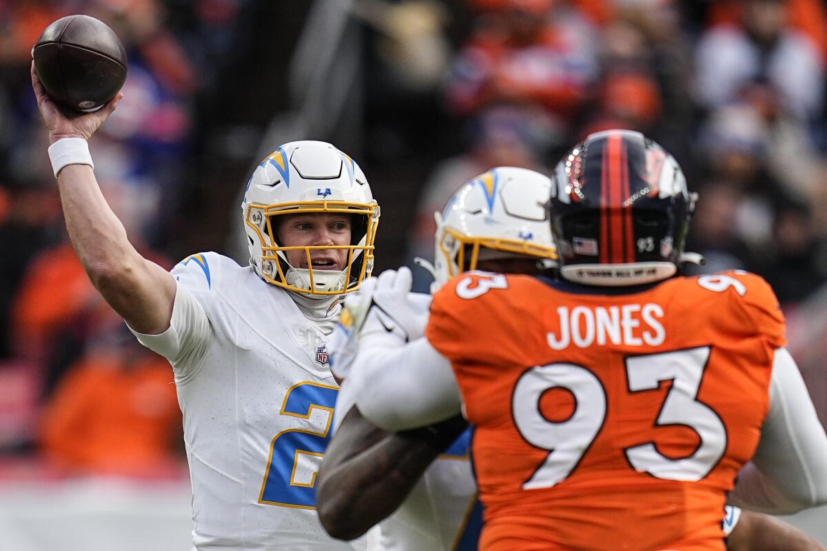 Chargers quarterback Easton Stick throws under pressure against the Broncos in the first half.