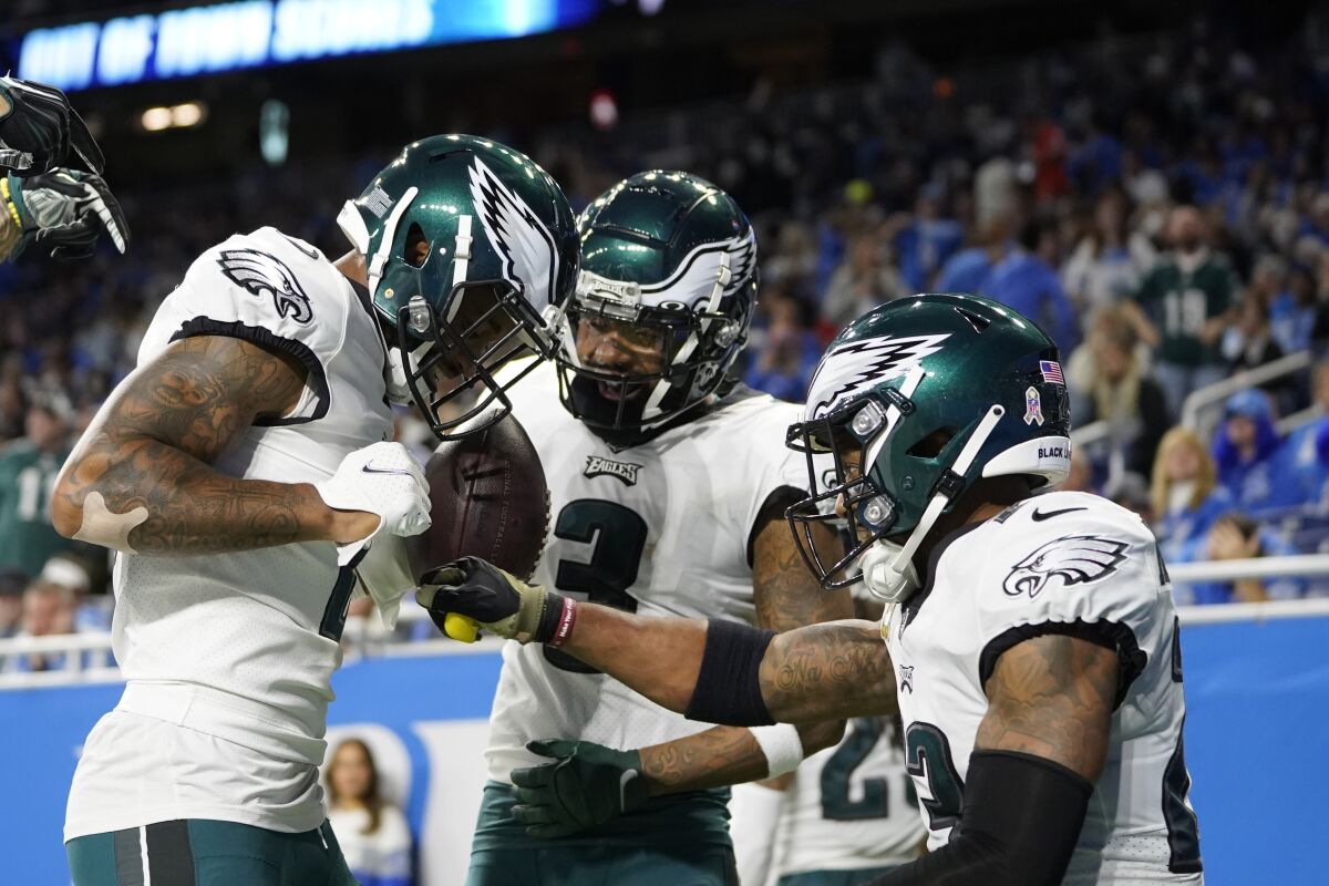 Philadelphia Eagles safety Rodney McLeod, right, hits the chest of cornerback Darius Slay after Slay's recovery of a Detroit Lions fumble for a touchdown during the second half of an NFL football game, Sunday, Oct. 31, 2021, in Detroit. (AP Photo/Paul Sancya)