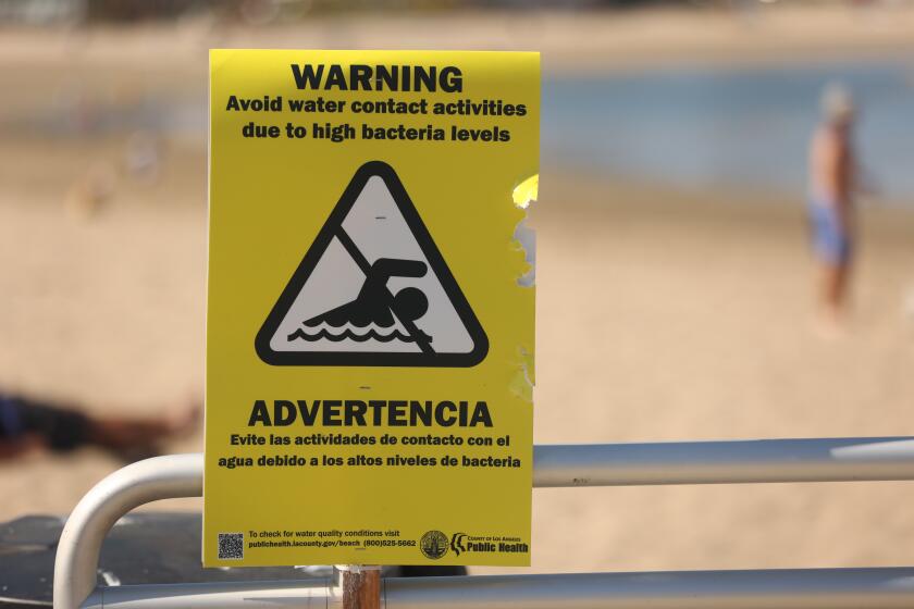 Marina del Ray, CA - May 25: A warning sign for people to avoid the water due to bacteria levels at Mother's Beach on Saturday, May 25, 2024 in Marina del Ray, CA. (Michael Blackshire / Los Angeles Times)