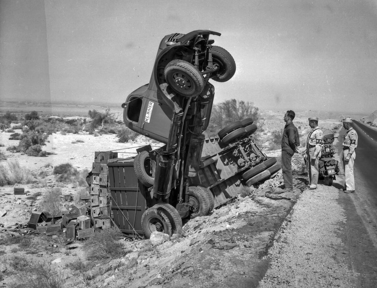June 6, 1943: Driver E.L. Bohanon and two Army MPs survey an Army truck accident. The only thing hurt were sodas.