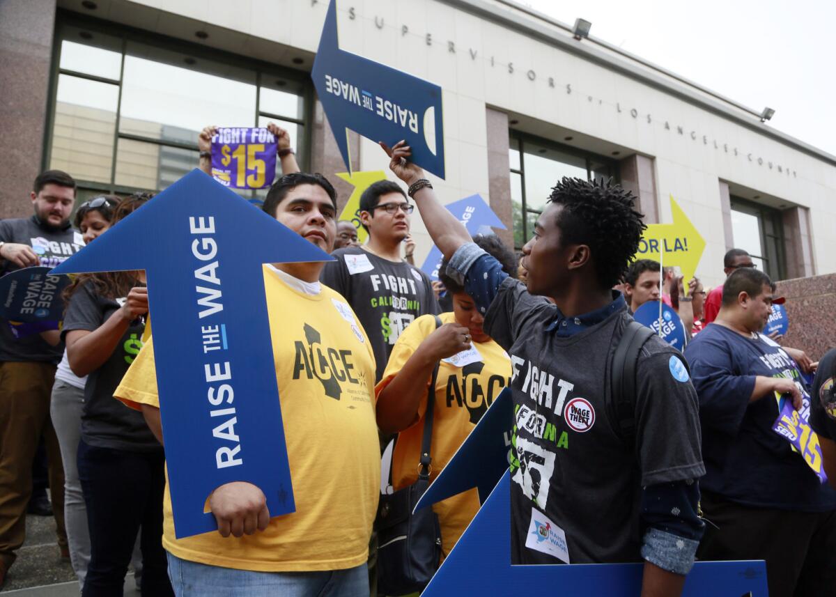 Workers hold a rally in support of the Los Angeles County Board of Supervisors' proposed minimum wage ordinance in July.