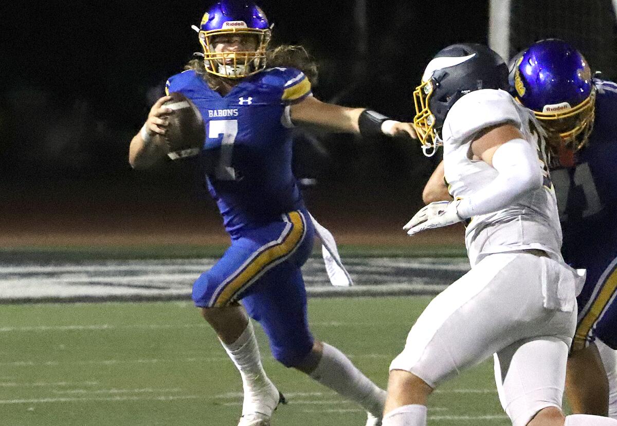 Fountain Valley quarterback Lucas Alexander (7) scrambles out of the pocket to pass against Marina on Friday.