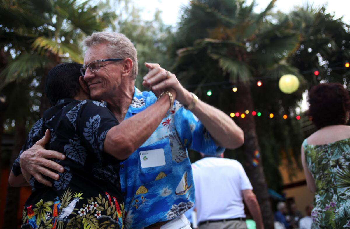 Frank Shoufer, right, dances with Robert Meza, left, at the Los Angeles Gay and Lesbian Center's senior prom.