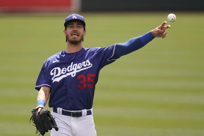 Los Angeles Dodgers' Cody Bellinger warms up prior to the team's spring training baseball game against the Milwaukee Brewers on Tuesday, March 16, 2021, in Phoenix. (AP Photo/Ross D. Franklin)