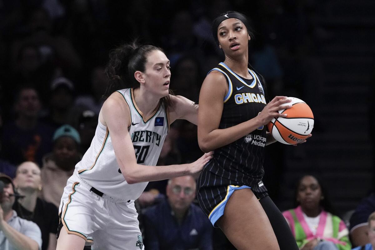 New York Liberty's Breanna Stewart defends against Chicago Sky's Angel Reese.